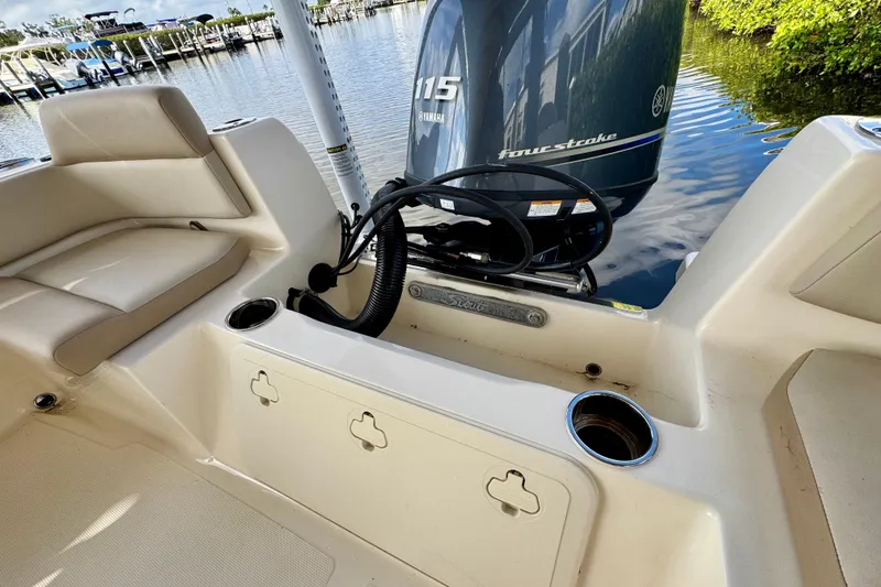 Slide: The Image of 2024 Scout 195 Sportfish boat interior with Yamaha 115 four-stroke engine at dock. - 18