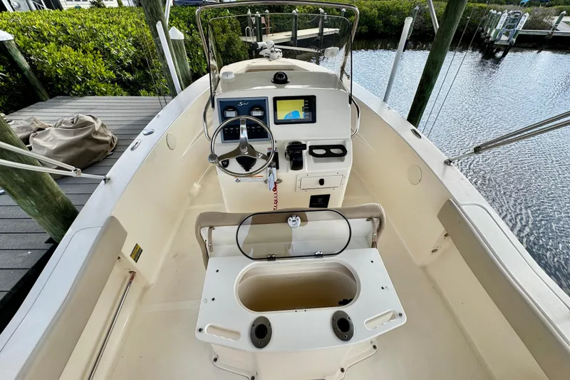 Slide: The Image of 2024 Scout 195 Sportfish boat interior with steering console and seating. - 24