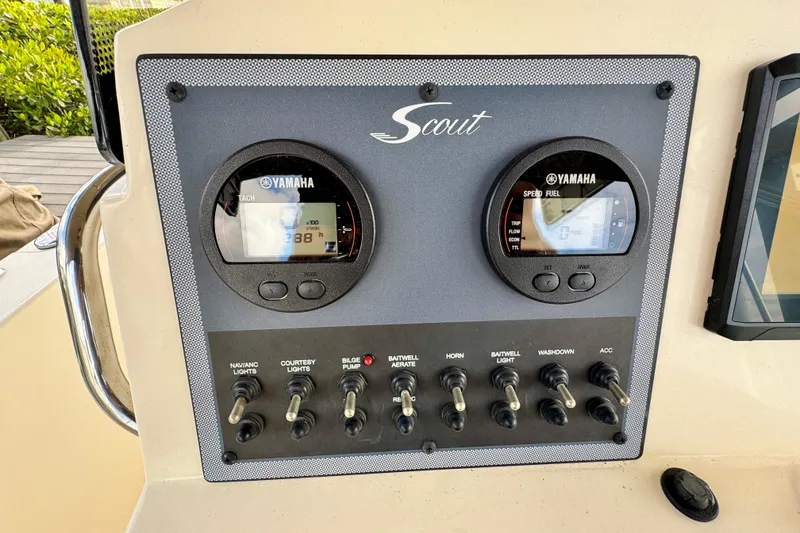 Slide: The Image of 2024 Scout 195 Sportfish dashboard with Yamaha gauges and control switches. - 28