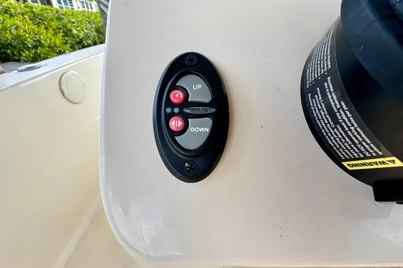 Slide: The Image of Control panel on 2024 Scout 195 Sportfish boat dashboard with up and down buttons. - 29