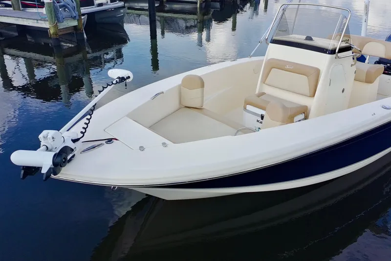 Slide: The Image of 2024 Scout 195 Sportfish boat docked, featuring sleek design and modern amenities. - 3