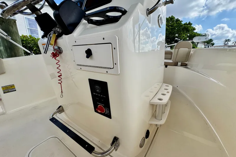 Slide: The Image of 2024 Scout 195 Sportfish boat console with steering wheel and control panel. - 30
