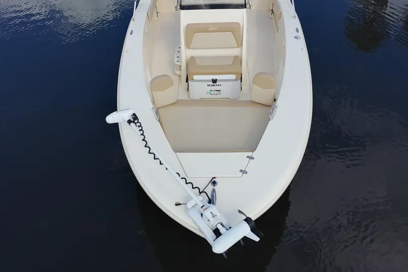 Slide: The Image of 2024 Scout 195 Sportfish boat with trolling motor on calm water. - 4