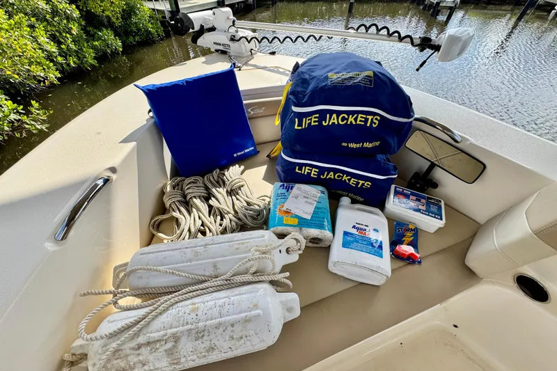 Slide: The Image of 2024 Scout 195 Sportfish boat with safety gear and life jackets on deck. - 43