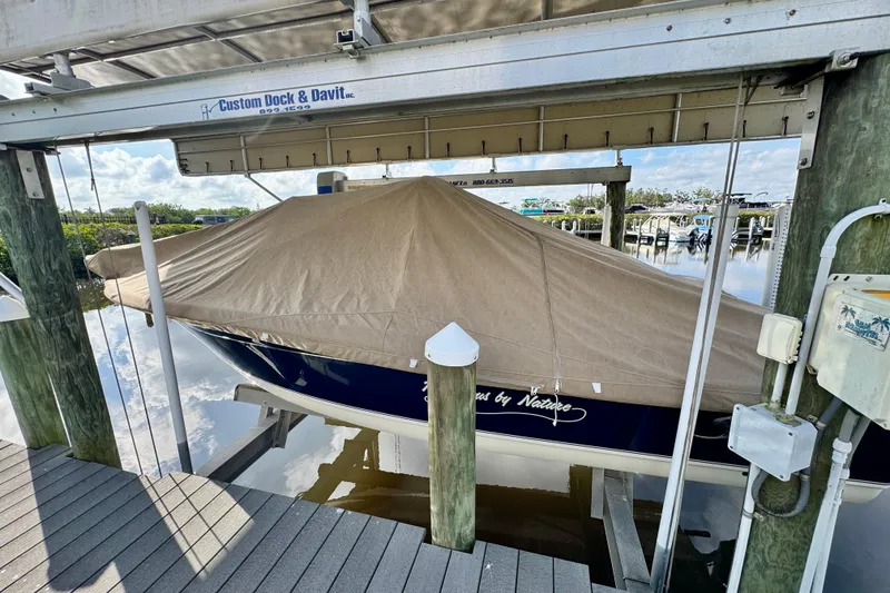 Slide: The Image of 2024 Scout 195 Sportfish boat covered and docked at marina. - 45