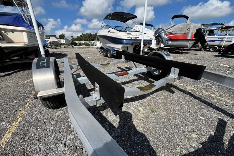 Slide: The Image of Boat trailer for 2024 Scout 195 Sportfish, parked in a marina under a clear sky. - 51