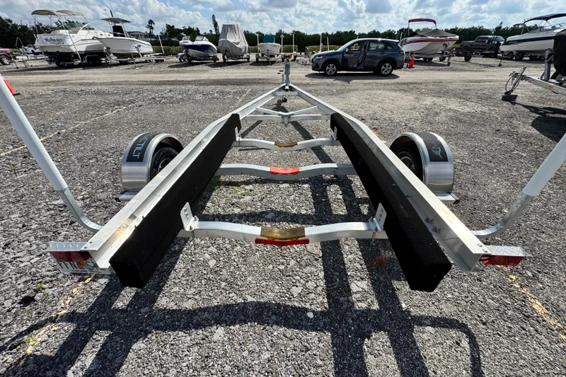 Slide: The Image of Boat trailer in a parking lot, surrounded by various boats and vehicles. - 53