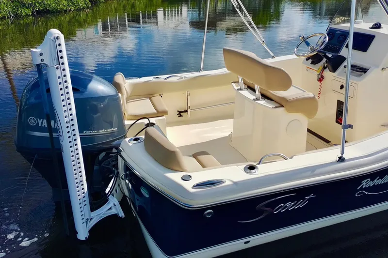 Slide: The Image of 2024 Scout 195 Sportfish boat with Yamaha engine on calm water. - 6