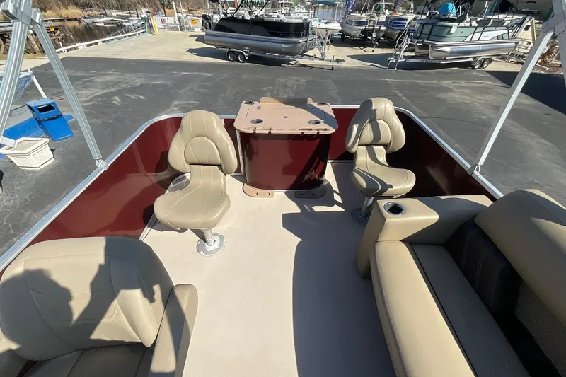 Slide: The Image of 2021 Sylvan Mirage Fish 820 Party Fish pontoon boat interior with beige seating and table. - 10