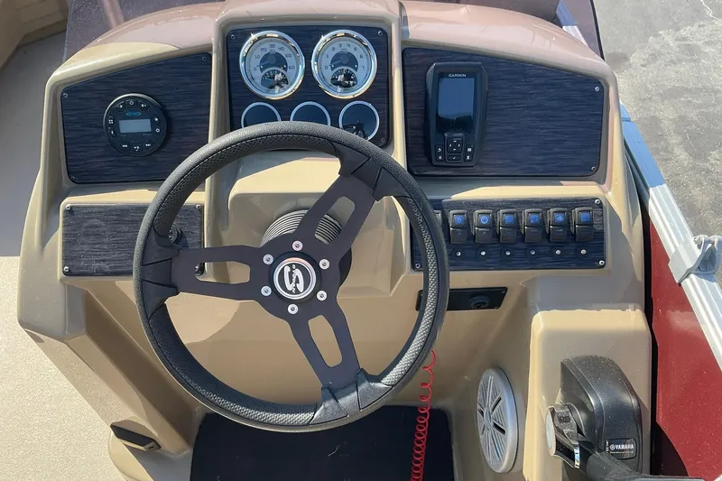 Slide: The Image of 2021 Sylvan Mirage Fish 820 Party Fish boat dashboard with steering wheel and controls. - 14