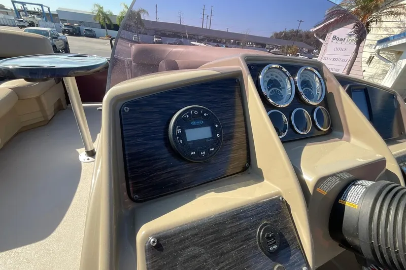 Slide: The Image of 2021 Sylvan Mirage Fish 820 Party Fish dashboard with gauges and controls in a sunny setting. - 17