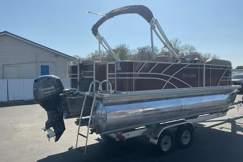 Slide: The Image of 2021 Sylvan Mirage Fish 820 Party Fish pontoon boat on trailer, with Yamaha outboard motor. - 4