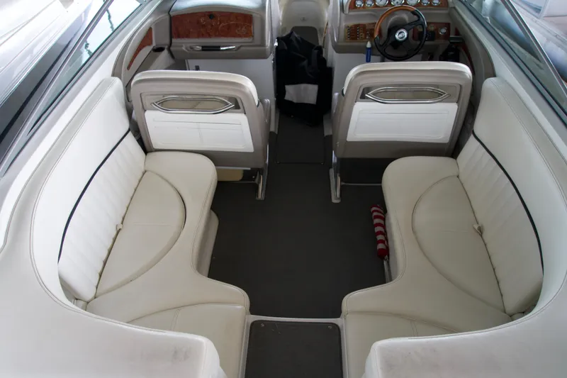 Slide: The Image of Interior of a 2005 Cobalt 262 boat with white seating and wood-accented dashboard. - 10