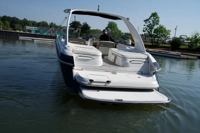 Slide: The Image of 2005 Cobalt 262 boat on water, rear view with open swim platform. - 3