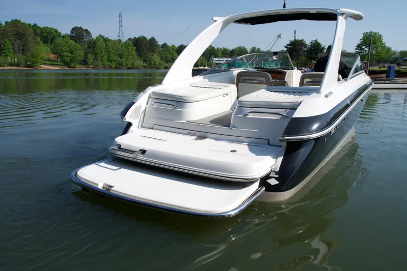 Slide: The Image of 2005 Cobalt 262 boat with swim platform on a serene lake. - 6