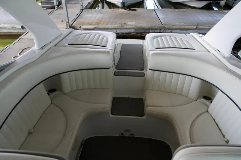 Slide: The Image of 2005 Cobalt 262 boat interior with white leather seating and sleek design. - 8