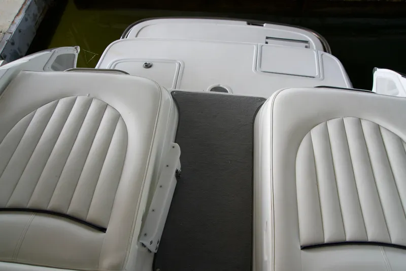 Slide: The Image of Interior view of a 2005 Cobalt 262 boat with white cushioned seats. - 9