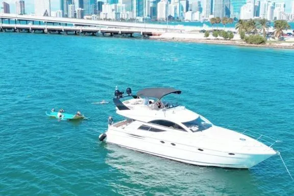 The Image of 2006 Fairline 50 yacht on turquoise water near city skyline. - 0