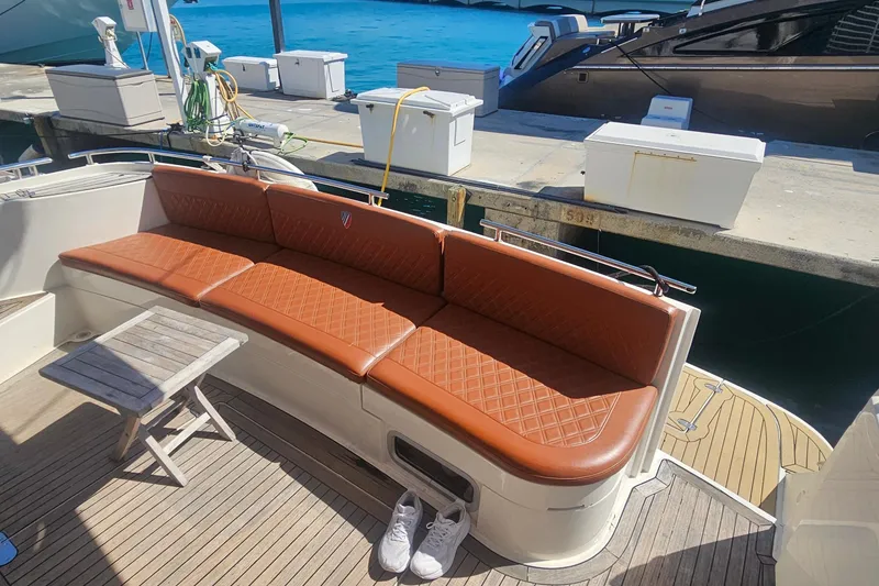 Slide: The Image of Luxurious 2006 Fairline 50 yacht with brown leather seating and wooden deck at marina. - 11