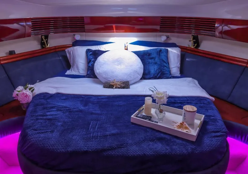Slide: The Image of Luxurious cabin interior of 2006 Fairline 50 yacht with elegant bedding and ambient lighting. - 16