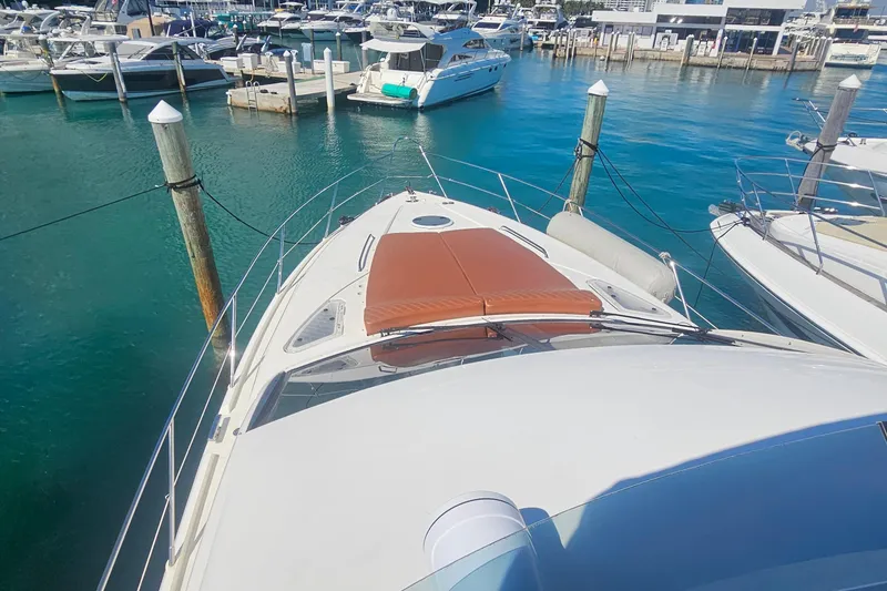Slide: The Image of 2006 Fairline 50 yacht docked in a marina with clear blue water. - 3