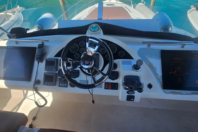 Slide: The Image of Cockpit of 2006 Fairline 50 yacht with steering wheel and navigation controls. - 5
