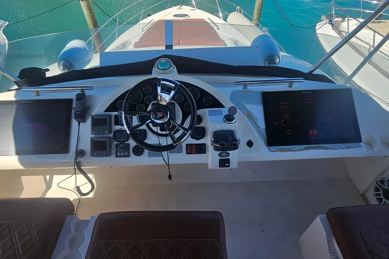 Slide: The Image of Cockpit of 2006 Fairline 50 yacht with modern navigation controls and dual screens. - 6