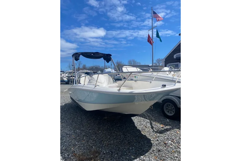 The Image of 2018 Boston Whaler 150 Super Sport boat on gravel lot. - 0