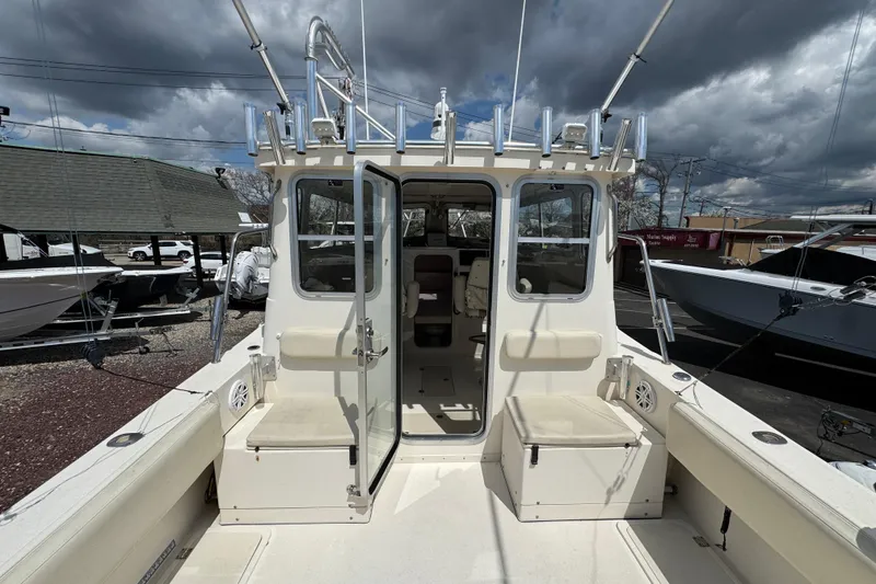 Slide: The Image of 2016 Defiance Admiral 270 EX boat with open cabin and fishing rod holders. - 10