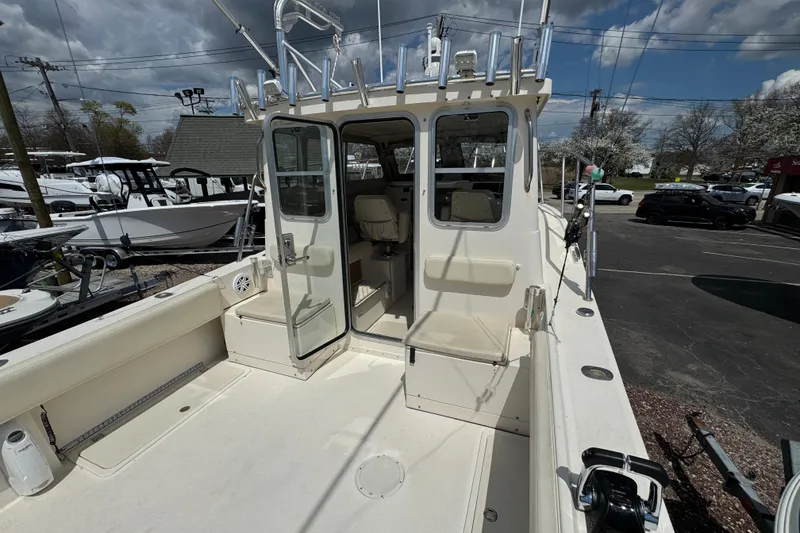 Slide: The Image of 2016 Defiance Admiral 270 EX boat with open cabin and fishing rod holders. - 13