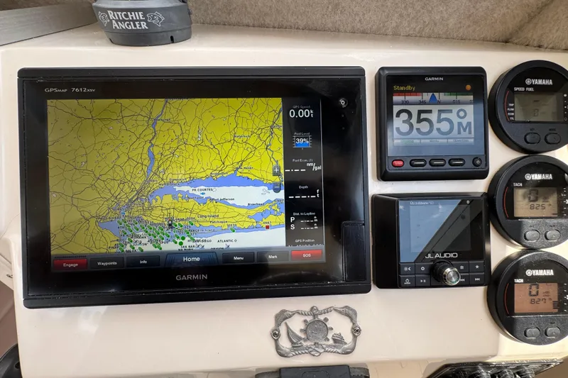 Slide: The Image of 2016 Defiance Admiral 270 EX dashboard with Garmin GPS, Yamaha gauges, and JL Audio system. - 14