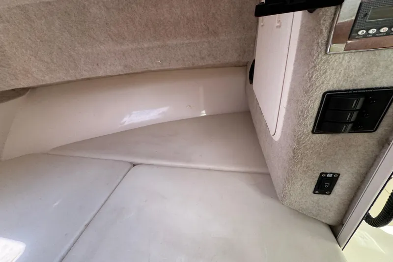 Slide: The Image of Interior cabin view of a 2016 Defiance Admiral 270 EX boat, featuring control panels. - 19