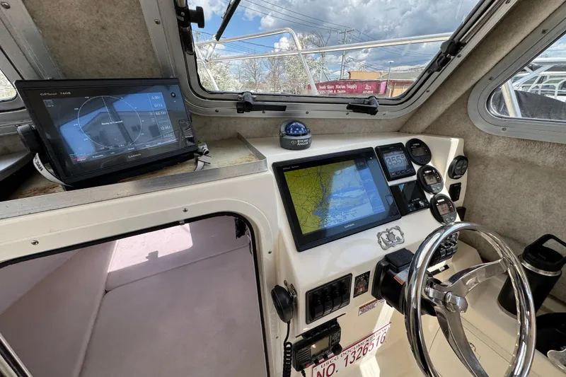 Slide: The Image of Interior of 2016 Defiance Admiral 270 EX boat with navigation equipment and steering wheel. - 21