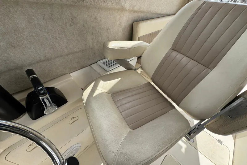 Slide: The Image of Captain's seat and controls of a 2016 Defiance Admiral 270 EX boat. - 22