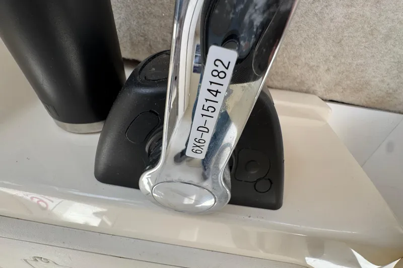 Slide: The Image of Close-up of a 2016 Defiance Admiral 270 EX boat throttle control. - 23