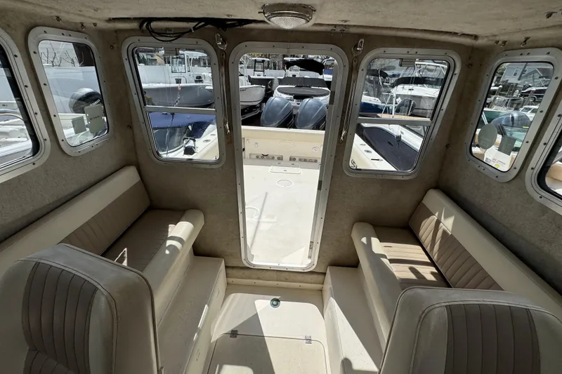 Slide: The Image of Interior of 2016 Defiance Admiral 270 EX boat with seating and windows. - 25