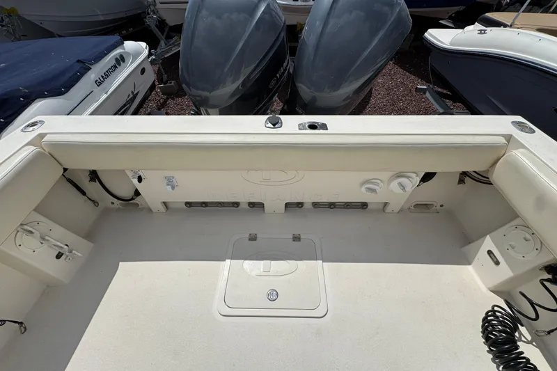 Slide: The Image of 2016 Defiance Admiral 270 EX boat interior with dual outboard motors. - 3