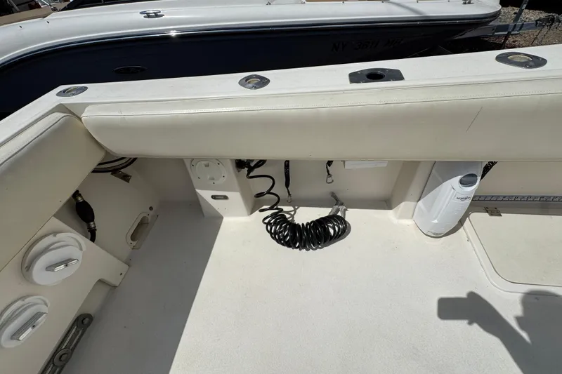 Slide: The Image of Interior view of a 2016 Defiance Admiral 270 EX boat, featuring seating and storage. - 4