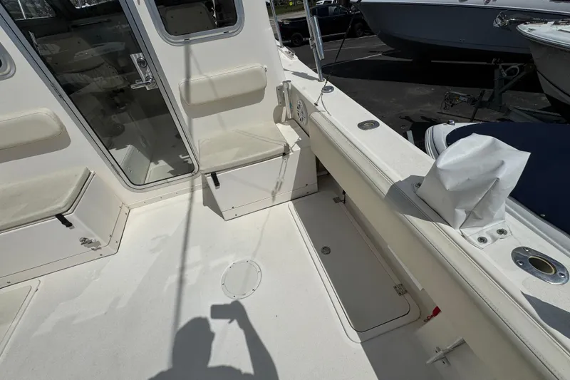 Slide: The Image of 2016 Defiance Admiral 270 EX boat interior with seating and storage compartments. - 7