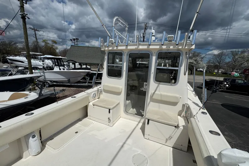 Slide: The Image of 2016 Defiance Admiral 270 EX boat with spacious deck and fishing rod holders. - 8