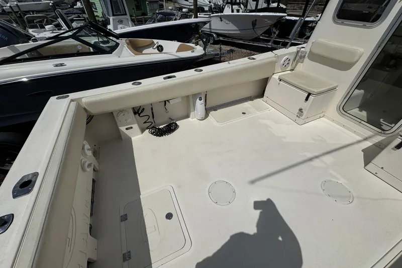 Slide: The Image of 2016 Defiance Admiral 270 EX boat deck with seating and storage compartments. - 9