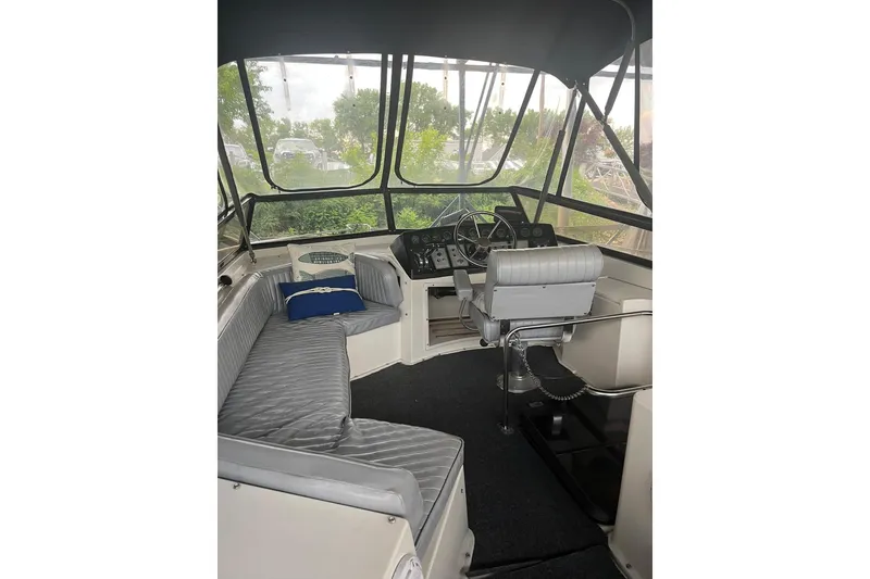 Slide: The Image of 1986 Carver 3297 Mariner boat interior with helm, seating, and panoramic windows. - 10