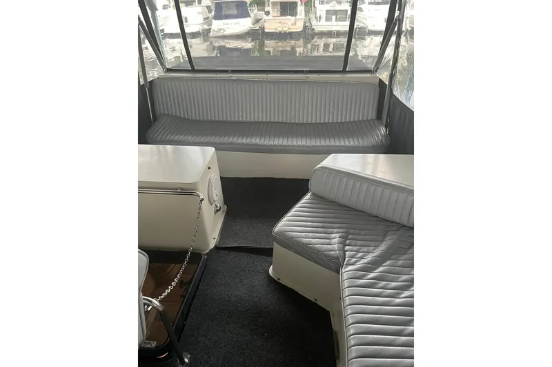 Slide: The Image of Interior of 1986 Carver 3297 Mariner with gray seating and carpeted floor. - 11