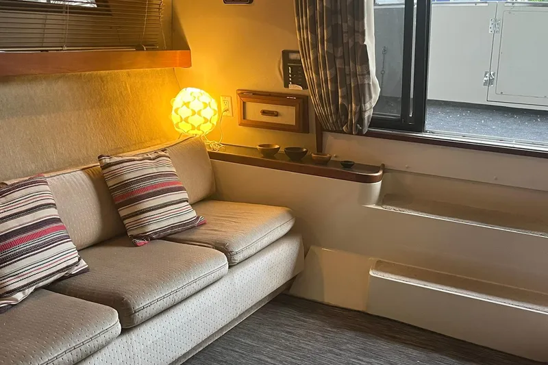 Slide: The Image of Cozy interior of 1986 Carver 3297 Mariner with sofa, pillows, and ambient lighting. - 5