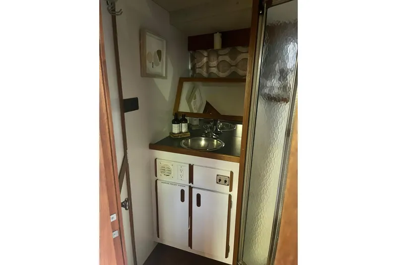Slide: The Image of 1986 Carver 3297 Mariner bathroom with sink, mirror, and storage cabinets. - 6
