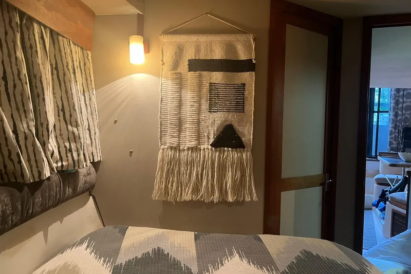 Slide: The Image of Cozy interior of 1986 Carver 3297 Mariner with wall hanging and patterned bedding. - 9