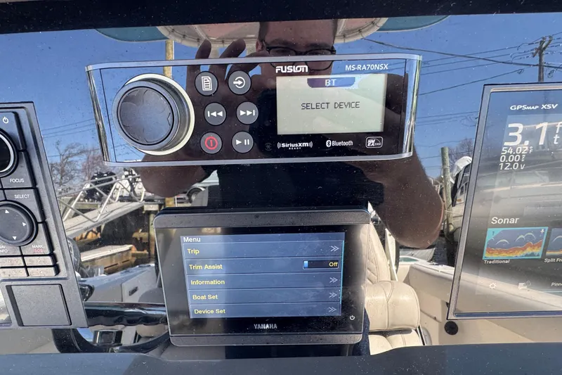 Slide: The Image of Control panel of a 2022 Sailfish 242 CC boat with navigation and audio systems. - 10