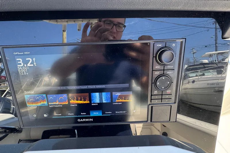 Slide: The Image of Garmin GPS display on 2022 Sailfish 242 CC boat, showing sonar and navigation options. - 11