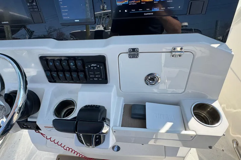Slide: The Image of 2022 Sailfish 242 CC boat dashboard with Garmin displays and control panel. - 13