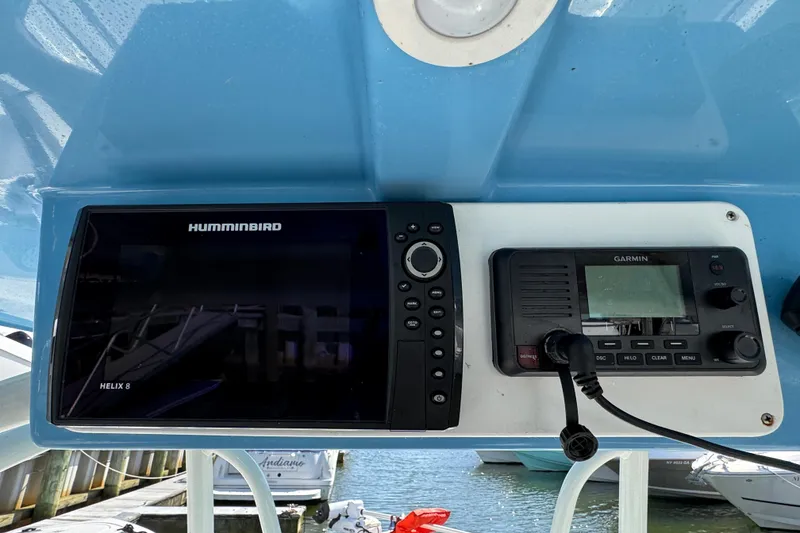Slide: The Image of Helm of 2022 Sailfish 242 CC with Humminbird and Garmin navigation systems. - 15